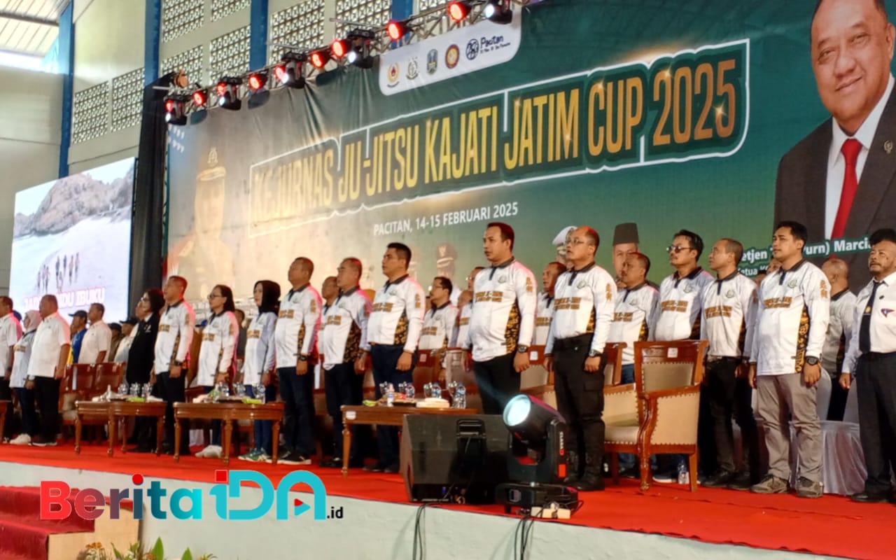 Menampilkan suasana pembukaan Kejurnas Ju-Jitsu Kajati Jatim Cup 2025 yang berlangsung di Pacitan pada 14-15 Februari 2025. Terlihat di atas panggung jajaran panitia, pejabat, dan tamu undangan mengenakan seragam resmi acara, berdiri dengan penuh khidmat. (Foto: Heri Nur Cahyo,/BeritaIDN)